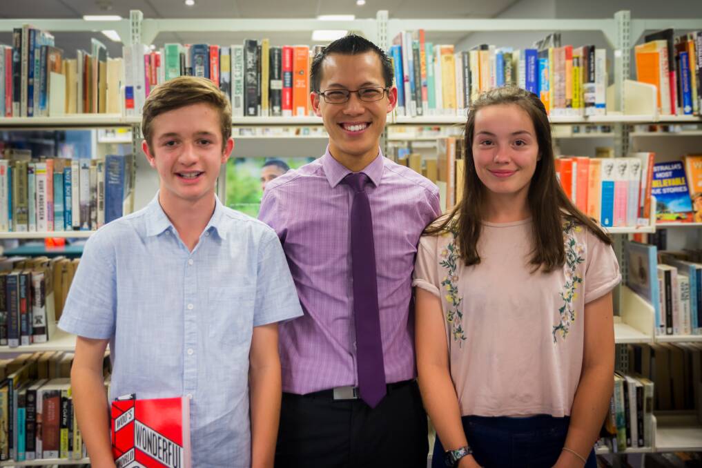 Making maths fun: Maths teacher Eddie Woo with students Liam Van Ravenstein and Tess Jordan during his visit to Sutherland Library.
