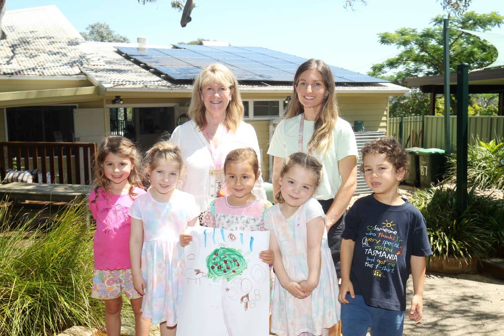The Point Preschool Director Catherine Lee and educator Megan Walsh pictured with children. The preschool is seeing some significant savings thanks to their solar project. Picture by Chris Lane