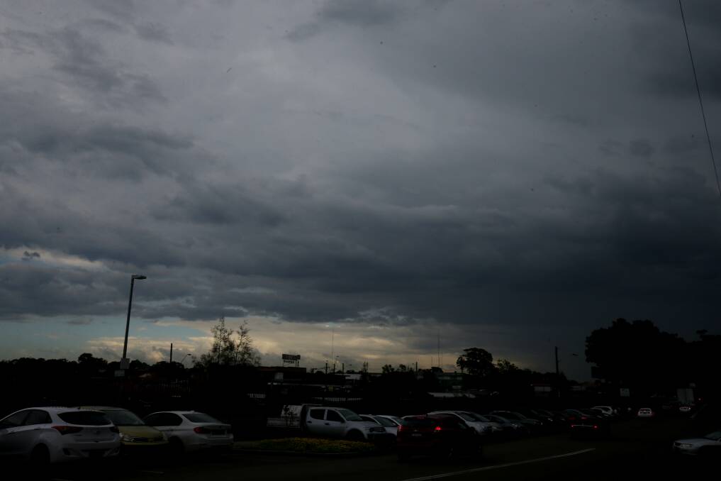 Darkness looms: A storm hits Sydney this afternoon. Picture: Chris Lane