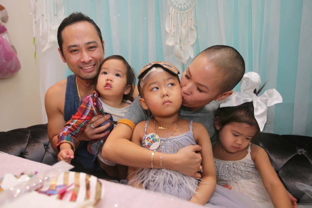 A fairy birthday party was held for Milan's 6th birthday last month. She is pictured with her father Minh and mother Marilee and siblings Major and Micah. Picture: John Veage