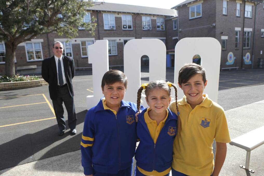 Milestone event: Carlton Public School pupils Victoria, 6, Jackson, 8, and Stevie, 10, with principal Stephen Vrachas, ahead of their centenary day.  Picture: John Veage 