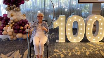 Beryl Hayles enjoys a glass of bubbly on her 100th birthday at Gymea Tradies. Picture supplied