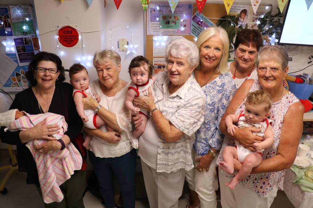 Mini-reunion: St George Hospital volunteers Amanda Carter, Lorna Yeterian, Barbara Noyes, Lorraine Alexander, Janelle King and Robyn Clark with baby Yu and 7-month-old triplets Bella, Eva and Sofia Coughtrey.
