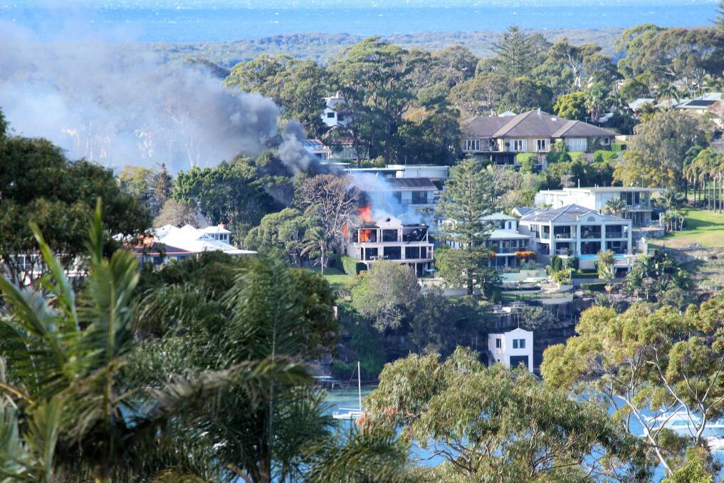 House fire: A resident took this photo on Monday morning of the house fire, clearly visible from her balcony. Picture: Sarah Burkitt. 