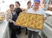 The team at Ibrahim Pastry Rockdale with a fresh batch of traditional Lebanese desserts. Picture by John Veage