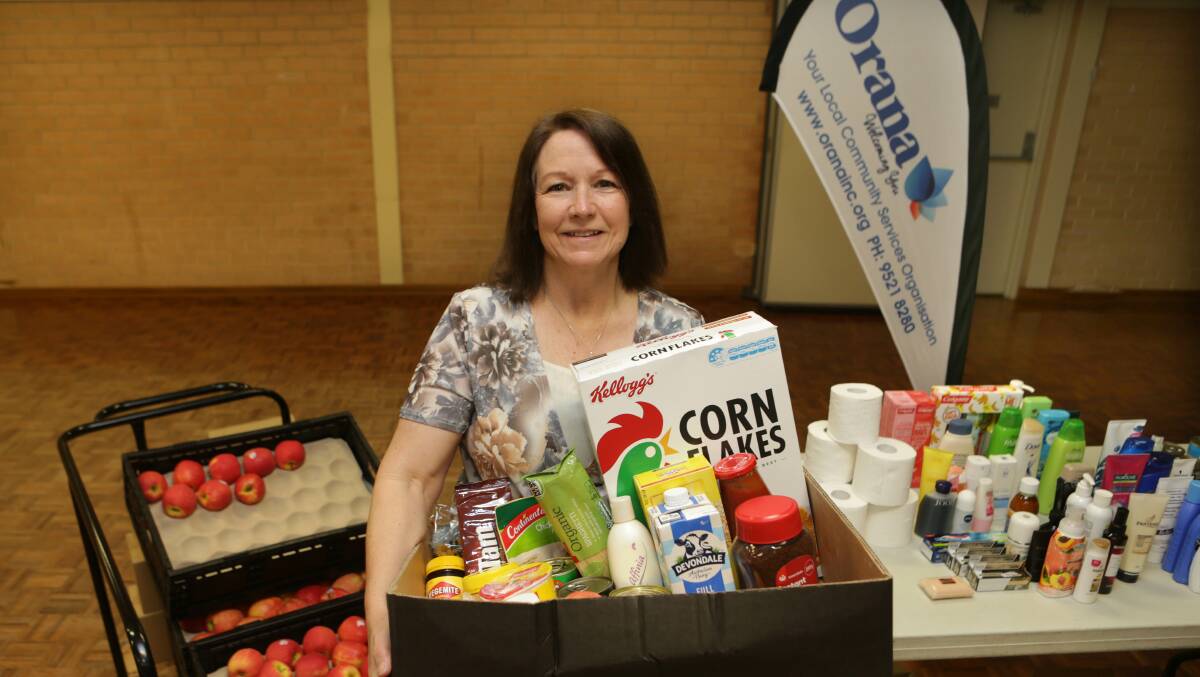Plea for help: Orana NSW Inc executive officer Elizabeth O'Neill with a food hamper. Picture: John Veage
