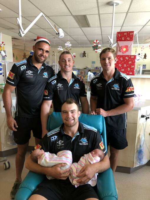 Festive spirit: Sharks players visited patients at Sutherland Hospital this week to spread some Christmas cheer.

