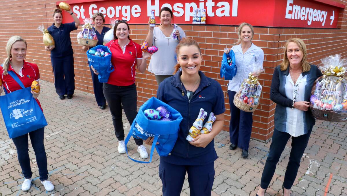 Chocolate fix: St George Hospital staff got a sweet surprise recently from Club Central staff (in red) Chantelle Chapman (left) and Kylie Di Cesare (right). Picture: Supplied.
