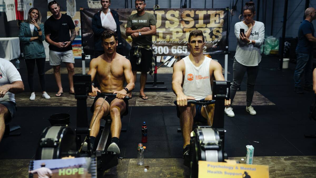 Row for a farmer: Tim Davis and Ash Nisbet worked out on rowing machines for 24 hours to raise money for drought-affected farmers. Pictures: Supplied 