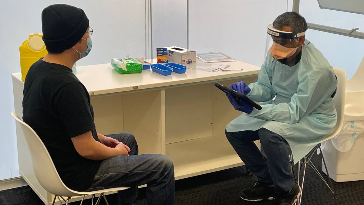 Bank jab: A staff member at a Commonwealth Bank branch in an area of concern prepares to get vaccinated recently at one of the hubs. Picture: Supplied

