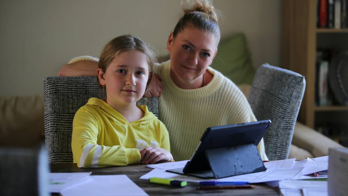 Remote learning: Tina Hunt and Phoebe, 10, get to work. Picture: John Veage