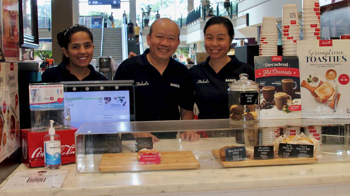 Major milestone: Paul Chen, centre, with staff at the Rockdale Plaza Michel's cafe he has operated for 20 years. Picture: Supplied