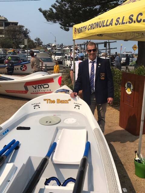 Name honour: Ausgrid employee and North Cronulla Surf Life Saving Club legend Barry Schuetrumpf with the surf boat named after him. Picture: Supplied