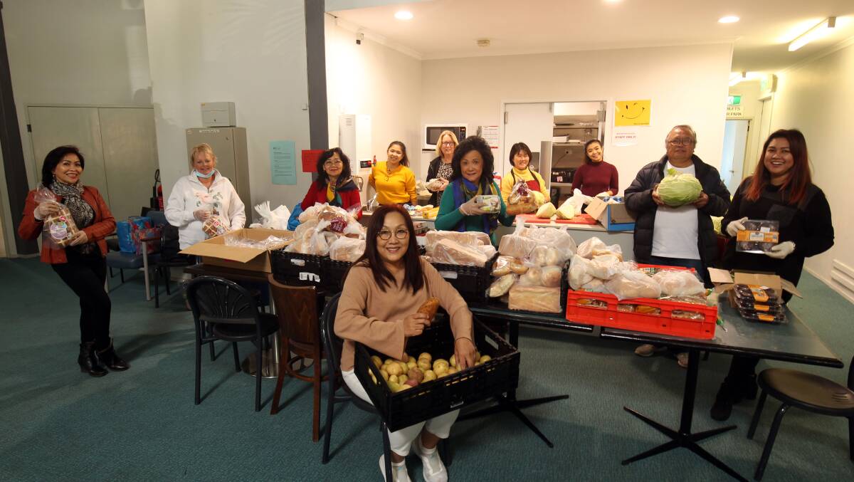 Helping hands: Volunteers and staff, includng general manager Lala Noronha (front) pack emergency food hampers. Picture: Chris Lane