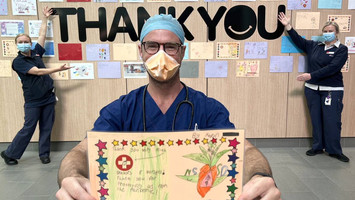 Giving thanks: St George Hospital anaesthetic registrar Dr Mitchell Warren and emergency department nurses Sara Smith and Felicity Cox with some of the cards from Oatley Public School and Good Start Early Learning, Carlton. Pictures: Supplied
