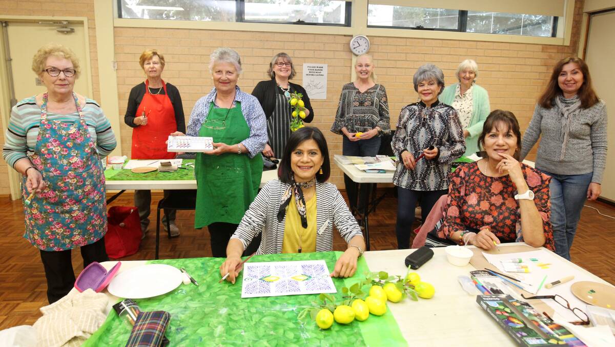 Colour me happy: Melissa Martin (centre front) with Artfully Social participants at Orana, Sutherland. Picture: Chris Lane
