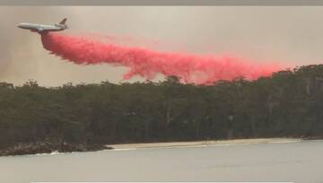 Welcome relief: A plane load of firefighting retardant was dropped on flames near Bendalong on New Year's Day. Picture: Facebook