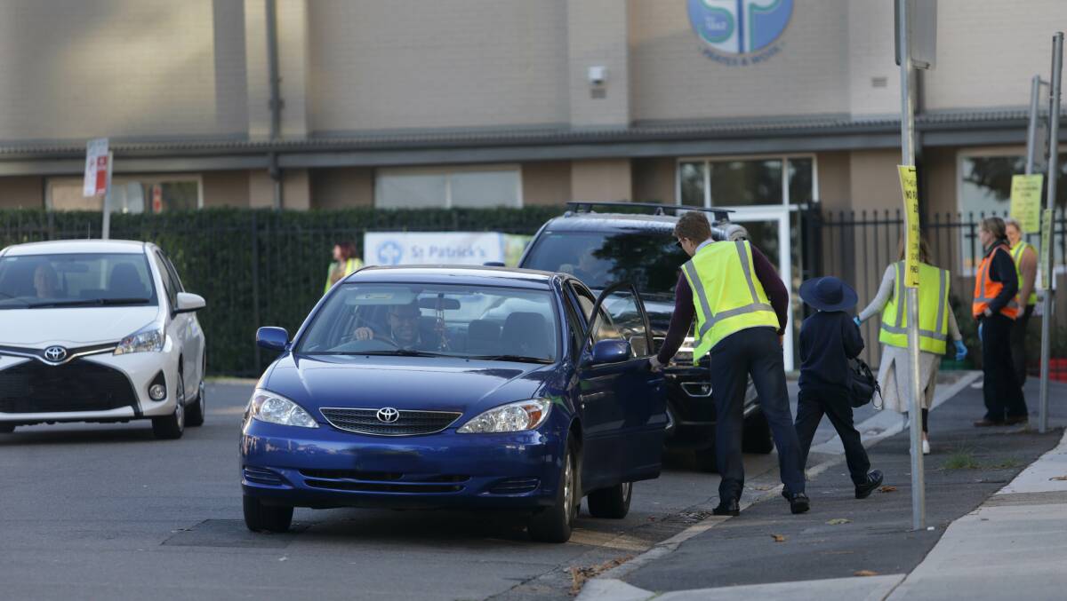 Organised chaos: St Patrick's at Kogarah has traffic wardens aiding pick-up and drop-off. Picture: John Veage