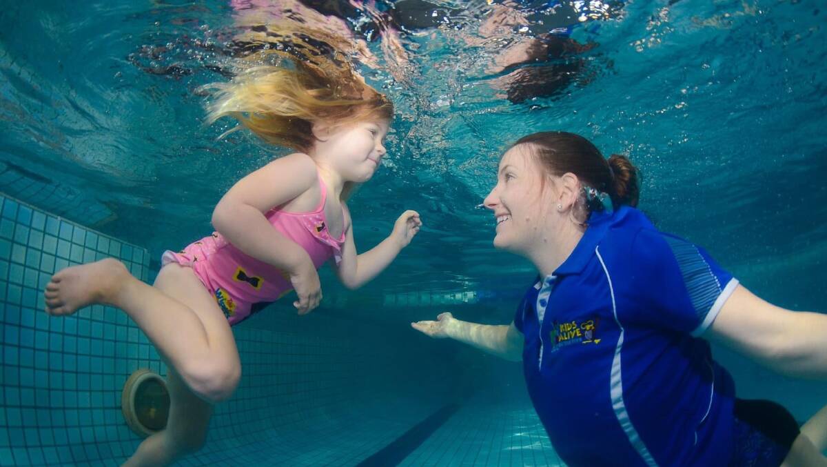 Saving kids' lives: Emma Lawrence teaches a child to swim. Picture: Supplied