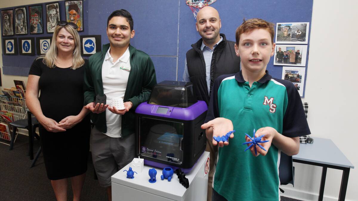 Sensory help: Assistant principal Sarah Ellingham, student Alessandro Balaguer, principal John Mazzitelli and student Billy Harrison with the new 3D printer. Picture: Chris Lane
