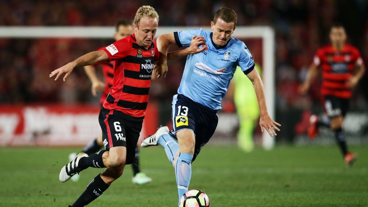 Game on: Western Sydney's Mitch Nichols (left) is challenged by Brandon O'Neill of Sydney FC during the round one A-League match. Picture: Matt King/Getty Images