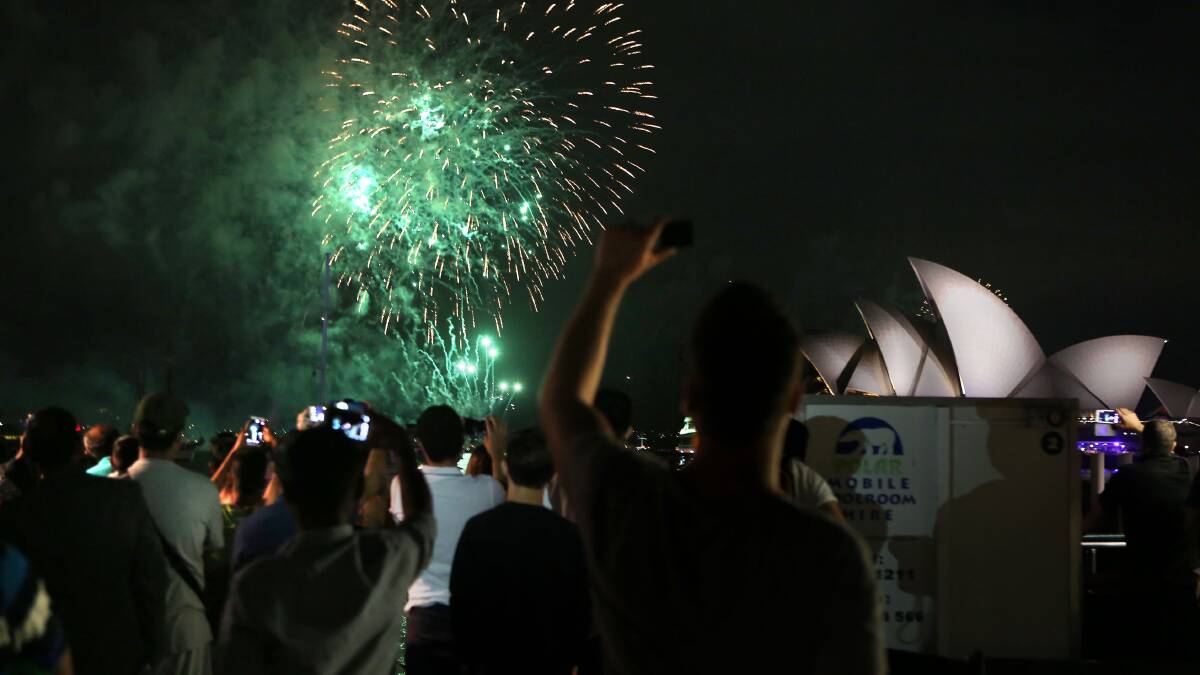 Bang: Revellers enjoy the Sydney Harbour fireworks last year. Picture: James Alcock