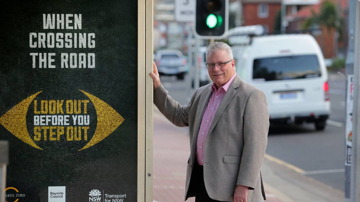 Safety first: Bayside Council Administrator Greg Wright with the poster that will adorn bus shelters across the area. Picture: John Veage