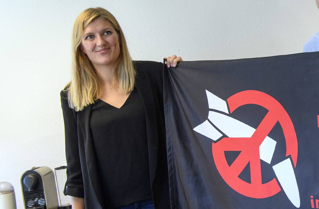 Raising awareness: Beatrice Fihn, Executive Director of the International Campaign to Abolish Nuclear Weapons (ICAN), poses with the ICAN flag in Geneva. Picture: AP