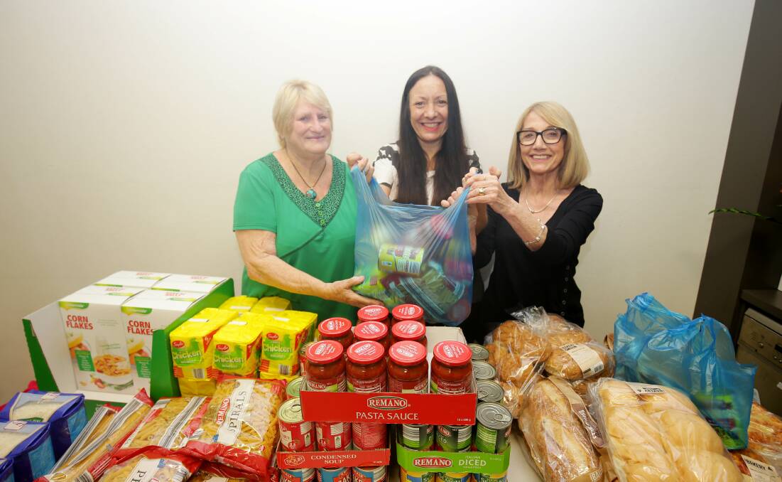 Relief service: Crossroads Community Care have opened a new free food pantry for families in need. From left, volunteer Wendy Williams, Crossroads' Lisa Lewis and volunteer Jane Cross. Picture: Chris Lane