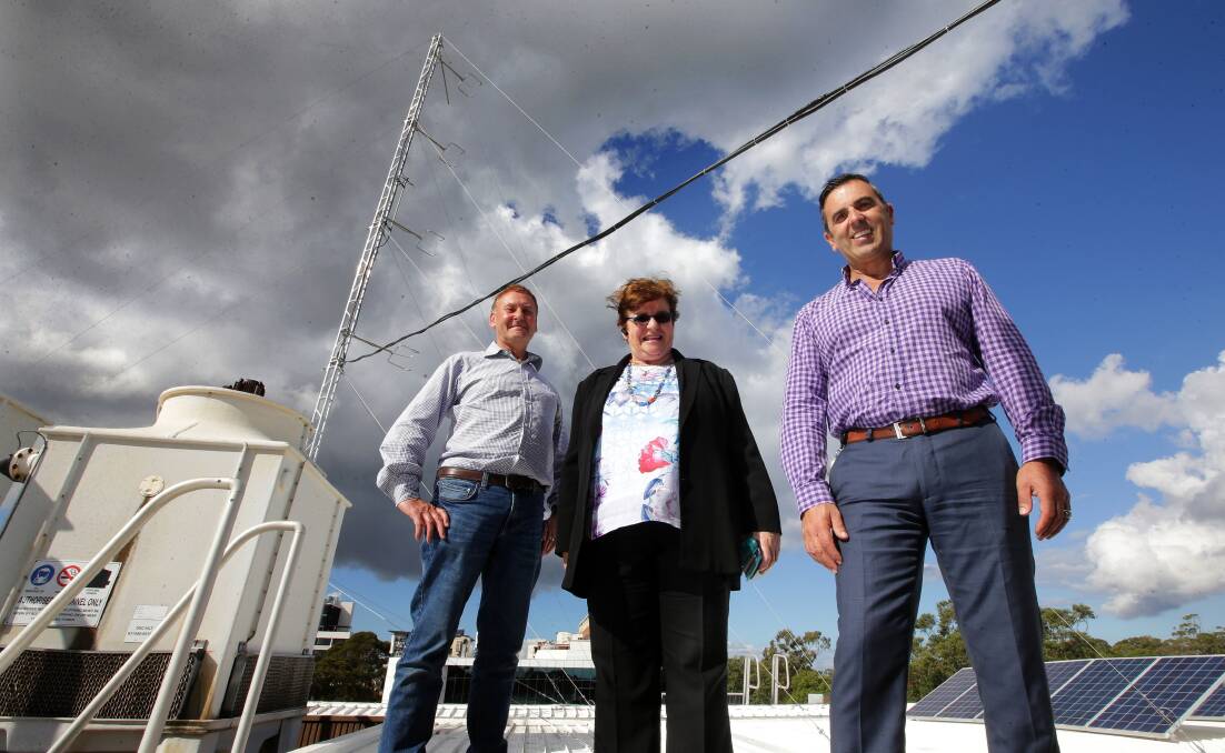 Now hear this: from left, Shire community radio station 2SSR 99.7 FM technical manager Lawrence Diamond, 2SSR general manager Gloria Gervasoni, and Sutherland Shire mayor Carmelo Pesce with the new transmitting tower on the roof of the council chambers. Picture: John Veage