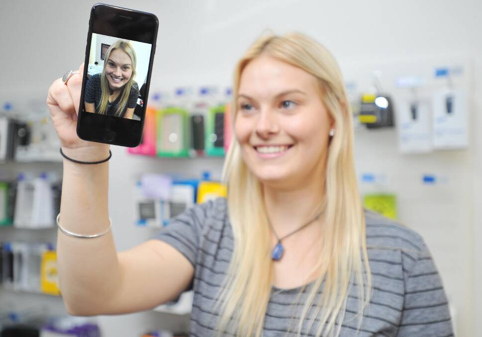 EXCITED: Ashlee Collins has fun with her new iPhone 7, which launched on Friday. Picture: Kieren L Tilly.