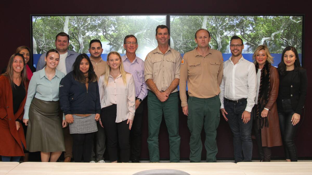 NPWS acting area manager Sam Reid and ranger Jason Bishop with Dicker Data staff. Picture supplied