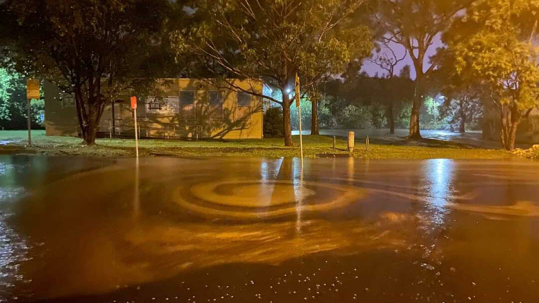 Oily water swirls at the roundabout on Captain Cook Drive after the overflow. Picture: Facebook