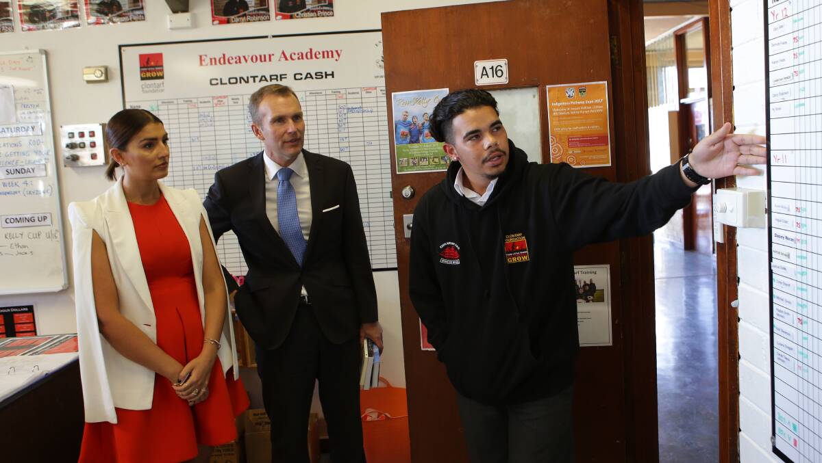 Student Gary Abel shows Education Minister Rob Stokes and Miranda MP Eleni Petinos some of Endeavour Sports High School's achievements. Picture: John Veage