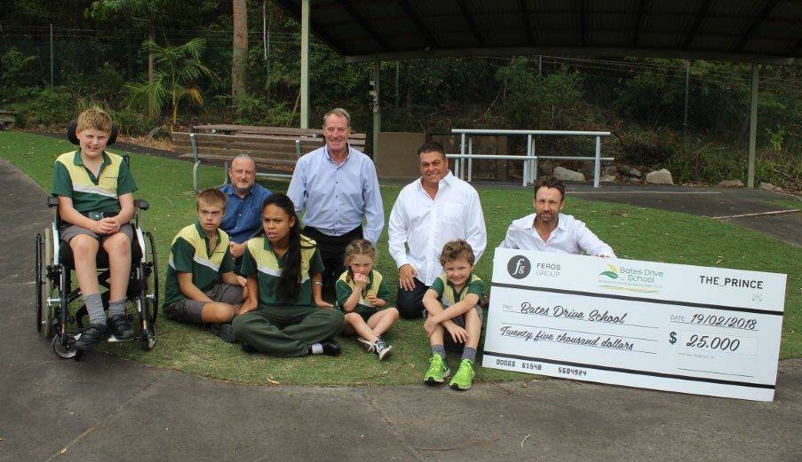 Feros Group chief executive Chris Feros, chief operating officer Simon Johnston and chief financial officer John Ryan make the presentation to Bates Drive Public School principal David Toogood and students. Picture: supplied

