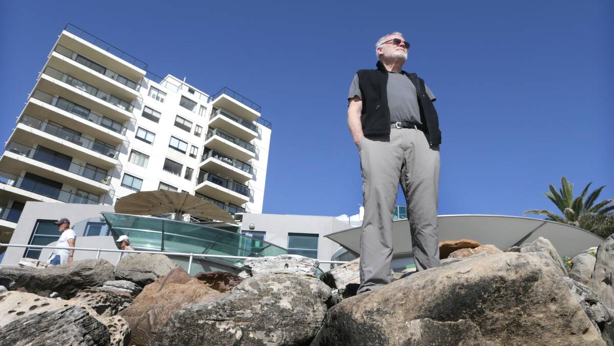 Watchful: Eric Hatfield at storm battered North Cronulla beach. He says the destructiveness of storms has increased due to climate change. Picture: John Veage