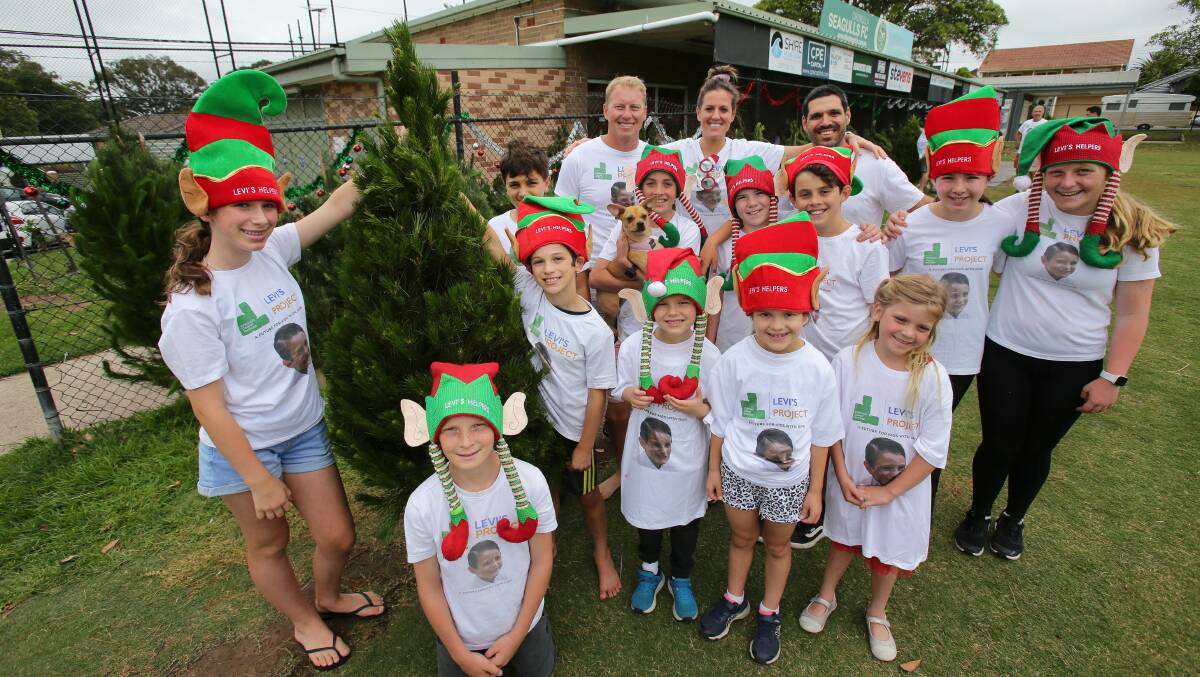  "Levi's helpers", including his siblings Olivia and Archie (holding tree), their father Ben (far right), Shara Reid and Andrew Holmes during the 2001 fund-raiser. Picture by John Veage