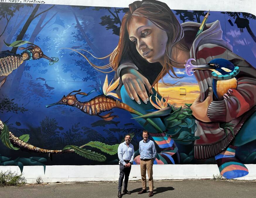 Cr Carmelo Pesce and Mark Speakman in the carpark of the former Westpac branch in Cronulla in front of a mural painted during the 2019 Walk the Walls festival. Picture supplied 