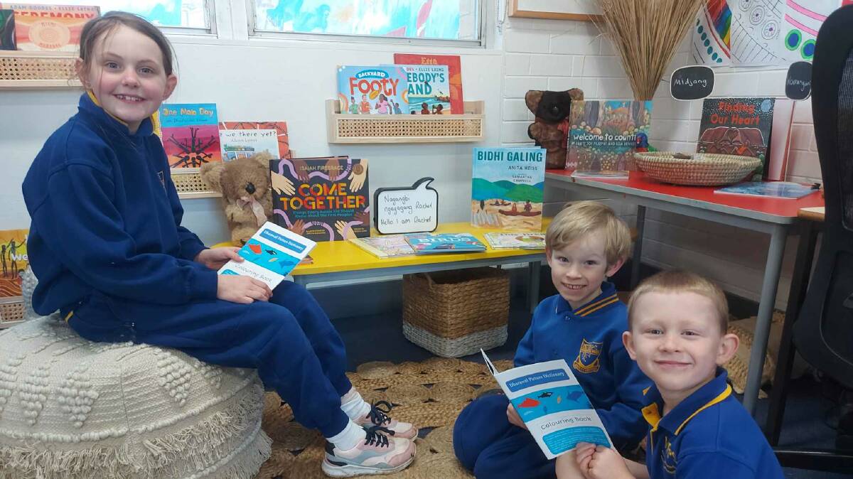 Children at Woronora River Public School with the Dharawal Picture Dictionary. Picture supplied