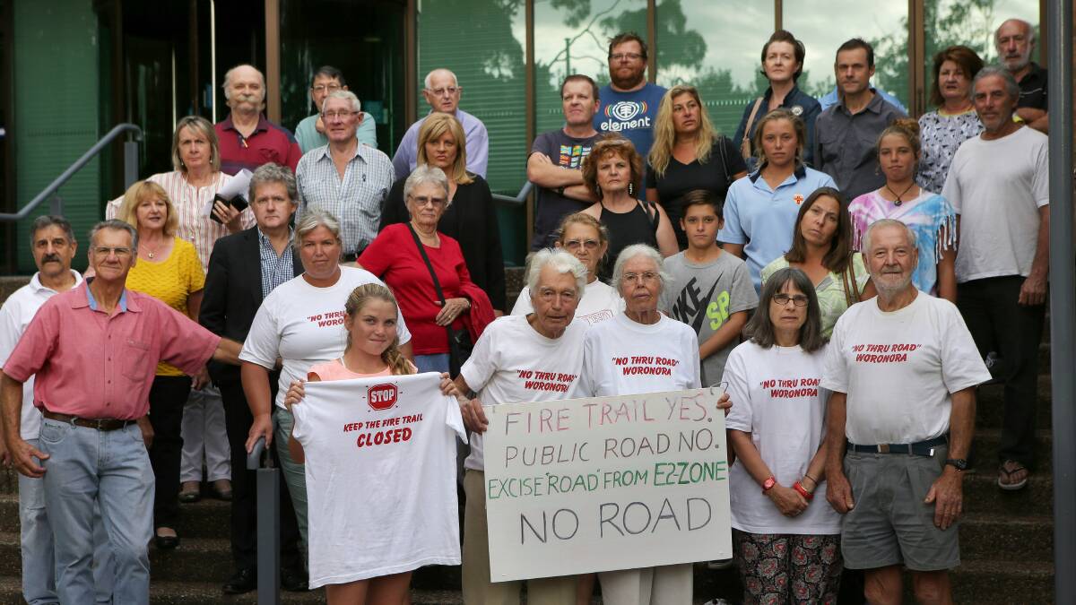 Norm Dixon (front, centre) with Woronora residents outside Sutherland Shire Council to stop an access road on the route of a fire trail between Woronora and Woronora Heights. Picture: John Veage