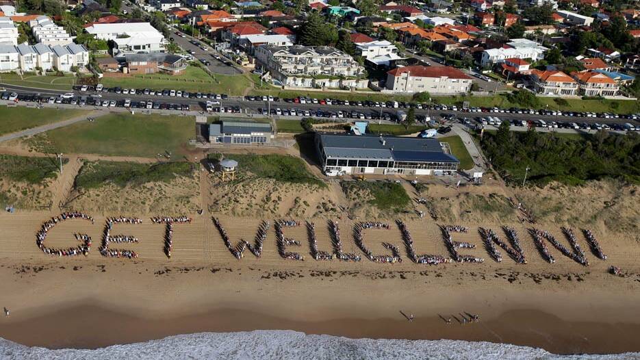2015 show of support: Hundreds of people turned out at Elouera Beach to spell out a heartfelt message to Glenn Wheeler. Picture: John Veage