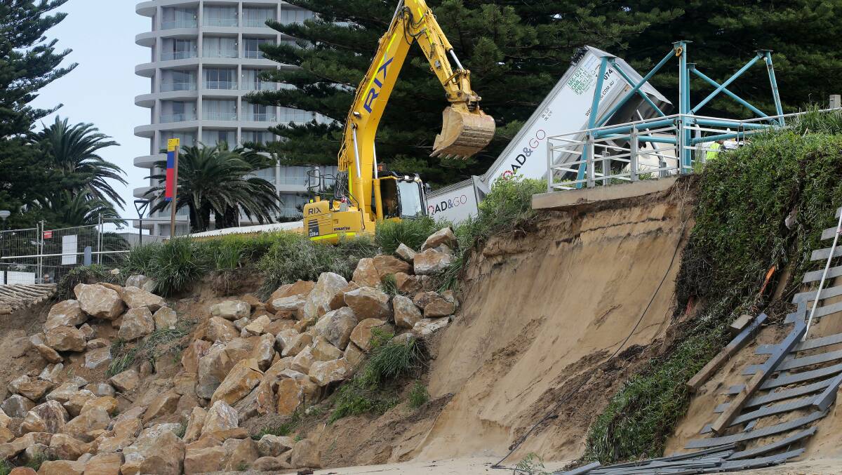 Work begins on building a three-metre high boulders seawall at North Cronulla. Picture: John Veage