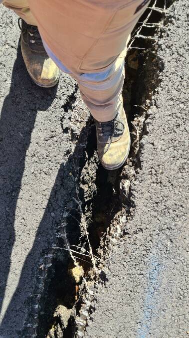 Cracking in the road pavement caused by rock and soil slippage Picture: supplied