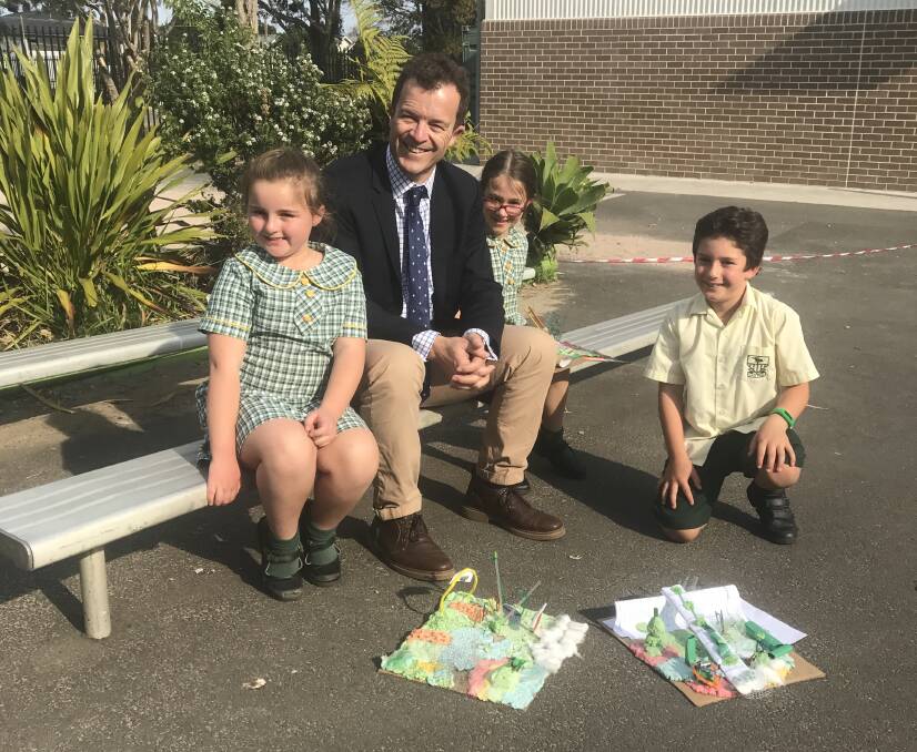 Cronulla MP Mark Speakman and pupils Lara (left) Kiara and Billy at Lilli Pilli Public School, where the P & C received $15,000 to refurbish the school playground.  Picture : supplied