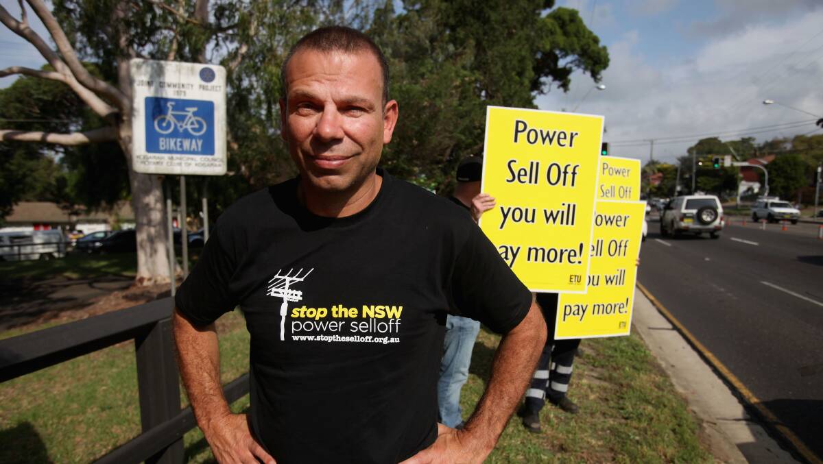 Mark Buttigieg in 2015 with signs along Princes Highway, Blakehurst, opposing electricity privatisation. Picture: Fiona Morris