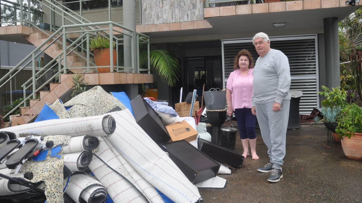Margaret and Peter Davis with flood-damaged household items at their Woronora home.