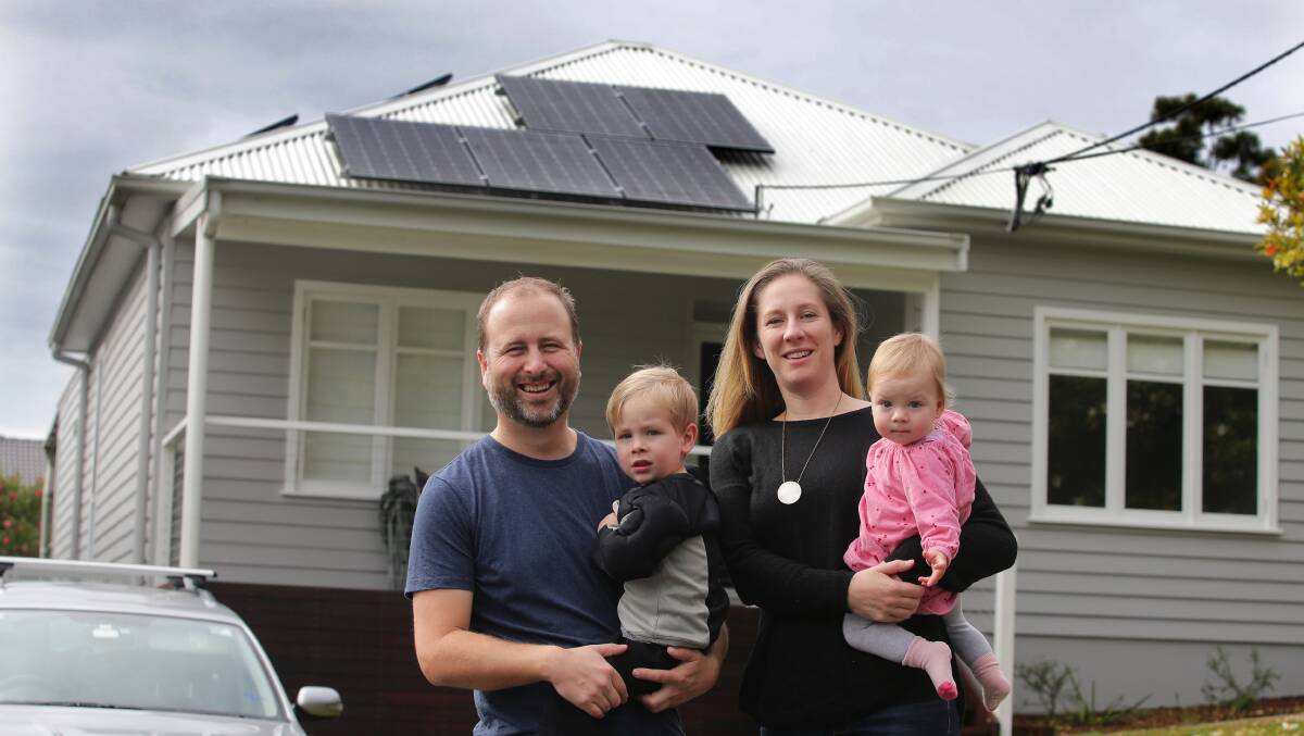 Jonathan Prendergast and Lauren Dragicevich and their children Leo and Olivia in front of their solar-powered home at Como. Picture: John Veage