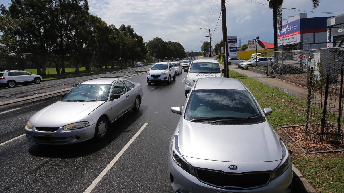 Parked cars restrict traffic on Taren Point Road outside of the present clearway hours. Picture: John Veage
