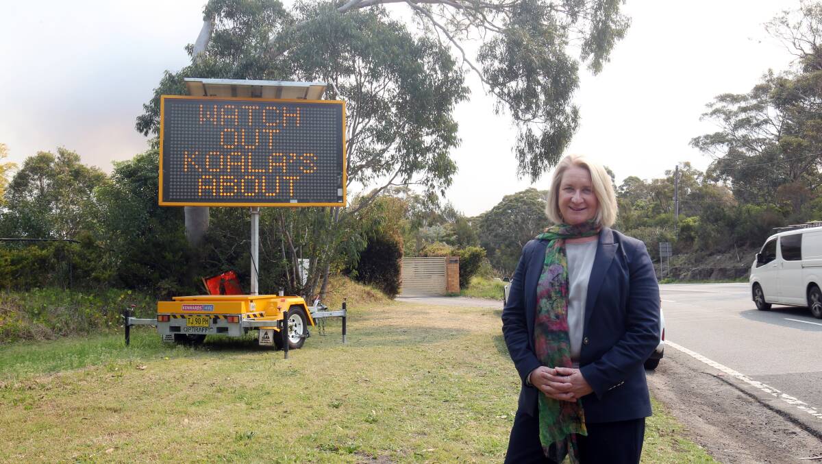 Maryanne Stuart and one of new signs on Heathcote Road. Picture by Chris Lane
