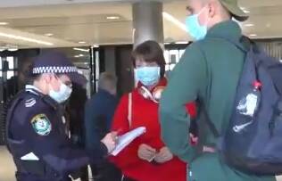 Police interview travellers from Melbourne on arrival at Sydney Airport. Picture: 9 News
